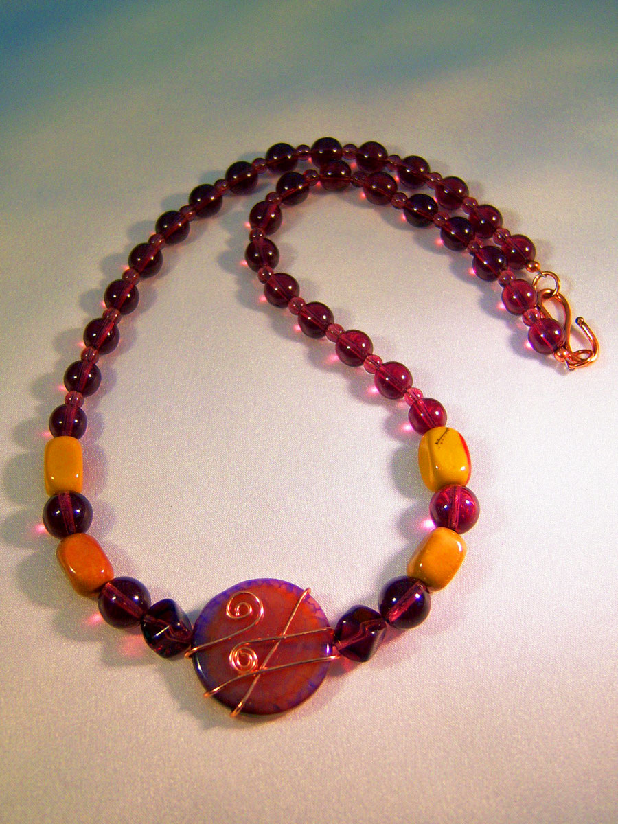 431n - 19 inch handcrafted necklace, wrapped focal, amethyst glass and moorkite black beads
